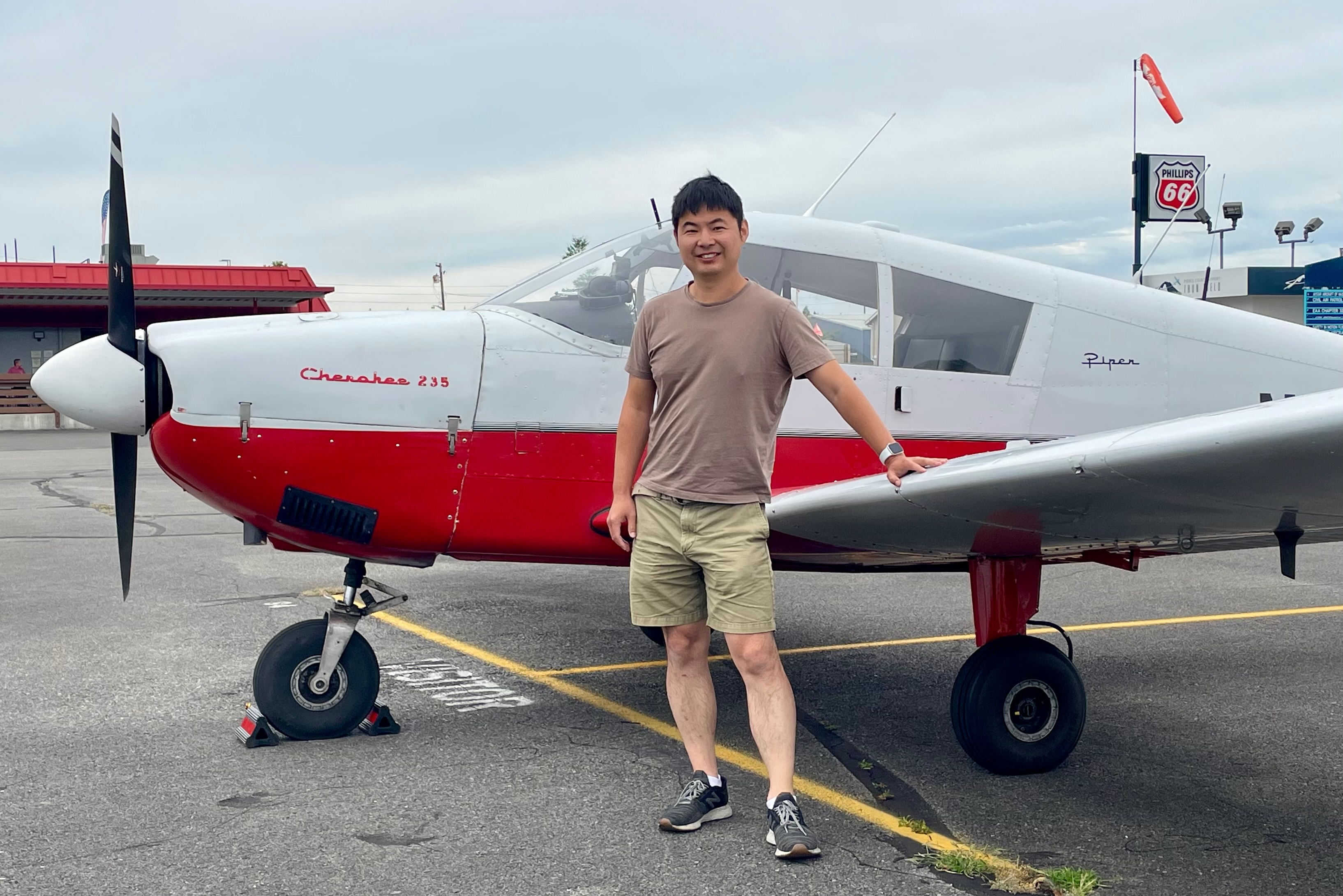 Todd Li standing next to a Piper Cherokee 235